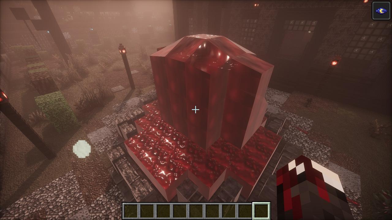 A great block of glossy red flesh grown up over grey stone in the fog