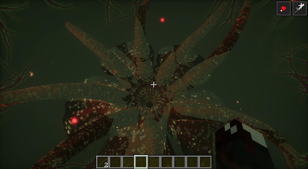 Looking up out of a throat of teeth, ringed by long spotted tentacles, in green murk